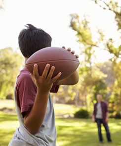 Kids throwing a football
