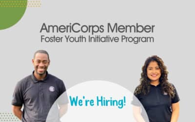 Two AmeriCorps Member with "We're Hiring!"