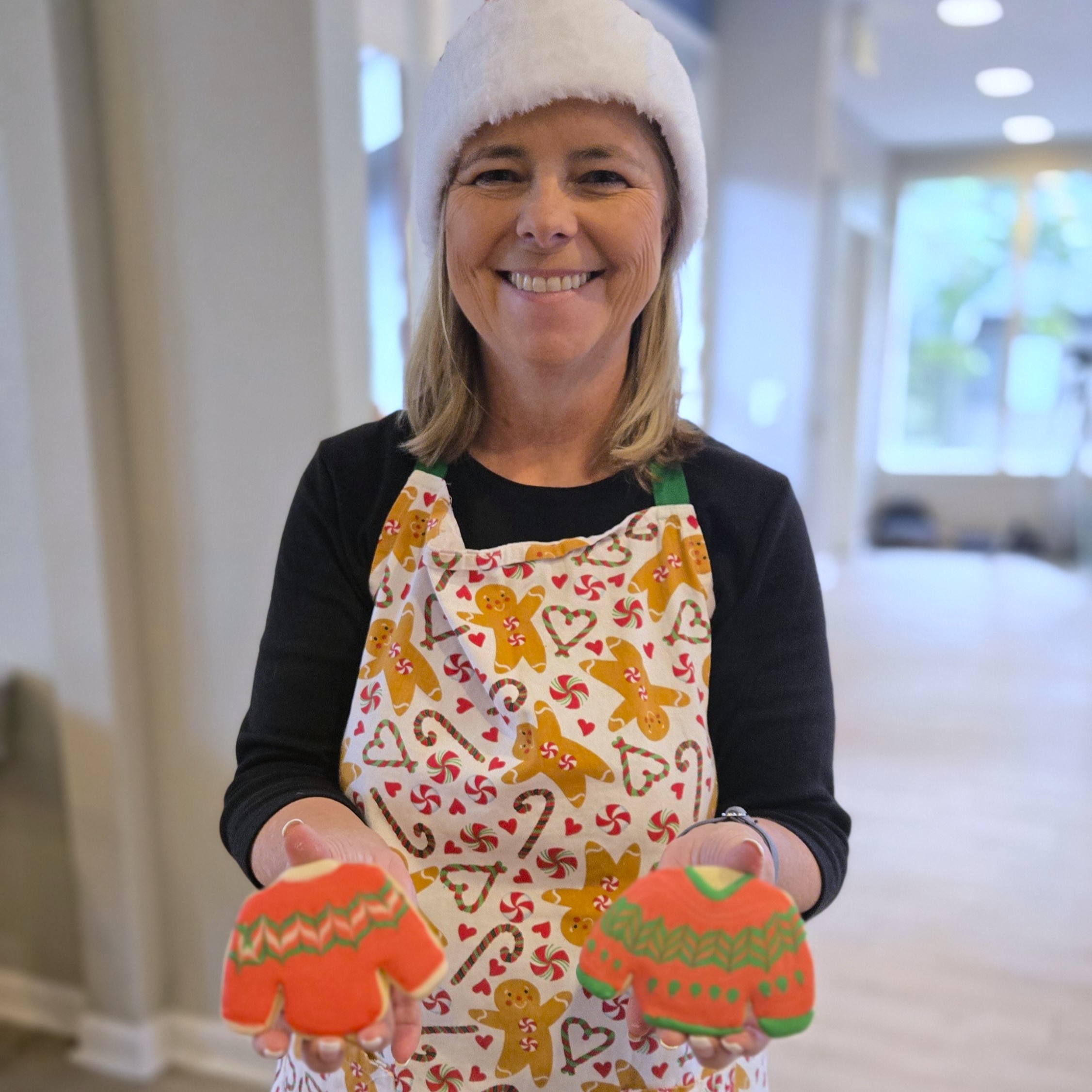 Mentor Kristin with cookies decorated n festive sweaters