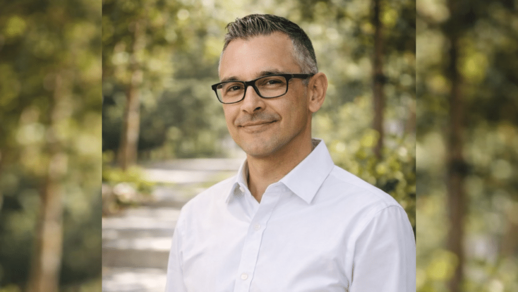 Member Martin in white collared shirt smiling